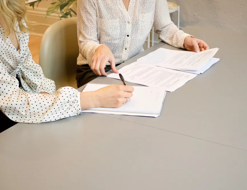 Colleagues signing documents